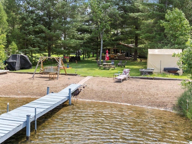 26803 Pelican Beach Rd, Merrifield, MN 56465 - dock area with a yard, an outdoor fire pit, a playground, and view of scattered trees