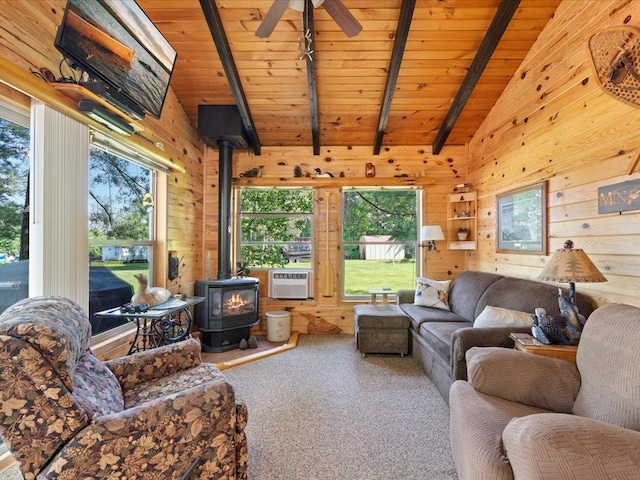 26803 Pelican Beach Rd, Merrifield, MN 56465 - living area featuring a wood stove, wooden ceiling, plenty of natural light, carpet, and wood walls