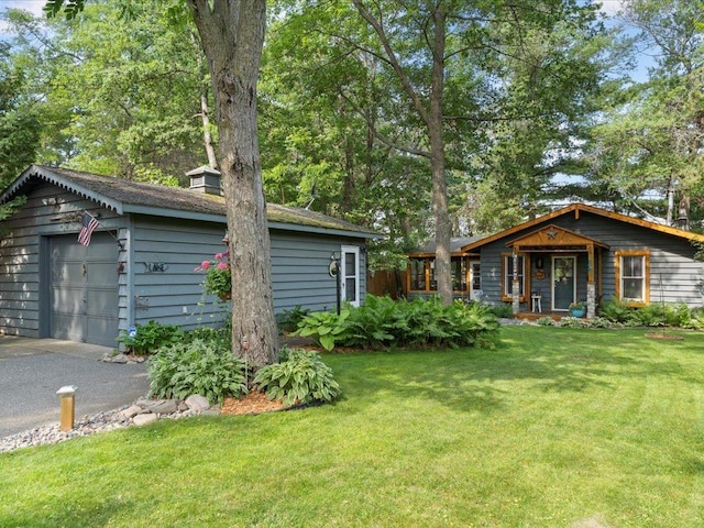26803 Pelican Beach Rd, Merrifield, MN 56465 - view of grassy yard featuring a detached garage and driveway