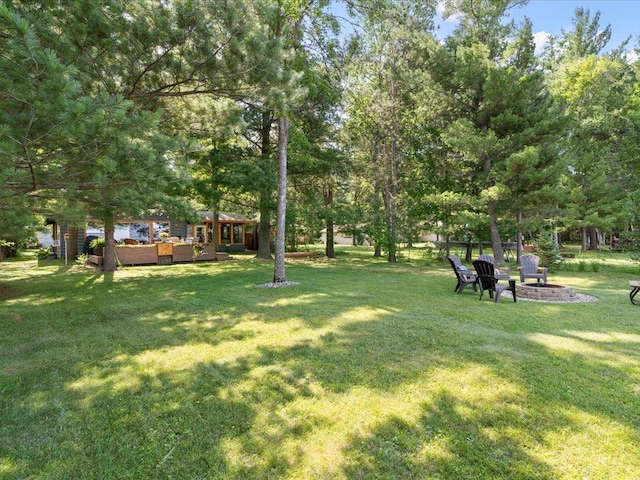 26803 Pelican Beach Rd, Merrifield, MN 56465 - view of green lawn with an outdoor living space with a fire pit