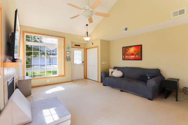 16424 Elm Creek Ln Unit 4029, Lakeville, MN 55044 - living room with light colored carpet, a glass covered fireplace, healthy amount of natural light, high vaulted ceiling, and a ceiling fan
