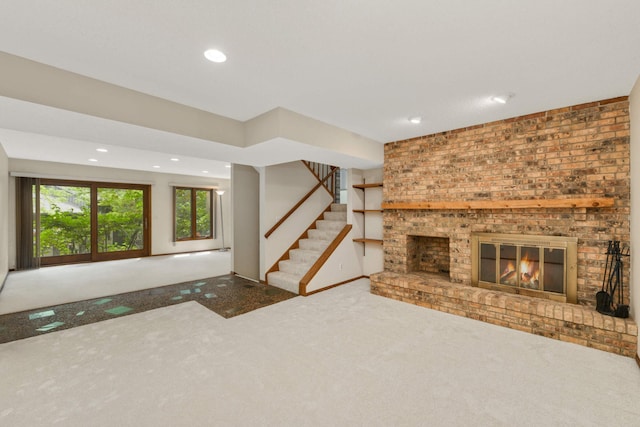 8040 Lea Rd, Bloomington, MN 55438 - unfurnished living room with carpet flooring, recessed lighting, stairs, and a brick fireplace