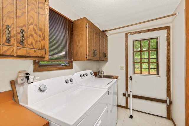 8040 Lea Rd, Bloomington, MN 55438 - laundry room with cabinet space, washing machine and dryer, a textured ceiling, and light tile patterned flooring