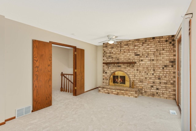 8040 Lea Rd, Bloomington, MN 55438 - unfurnished living room featuring a ceiling fan, carpet flooring, and a brick fireplace