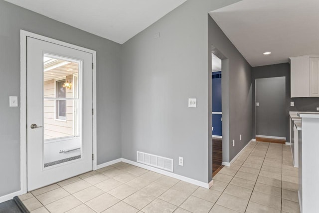 2100 10th St SW, Austin, MN 55912 - kitchen featuring light tile patterned floors, white cabinetry, and light countertops