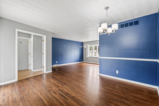 2100 10th St SW, Austin, MN 55912 - empty room with a chandelier and wood finished floors