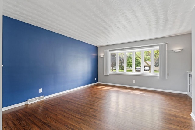 2100 10th St SW, Austin, MN 55912 - unfurnished room with wood finished floors and a textured ceiling