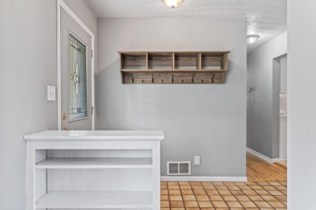 2100 10th St SW, Austin, MN 55912 - mudroom featuring baseboards and tile patterned floors