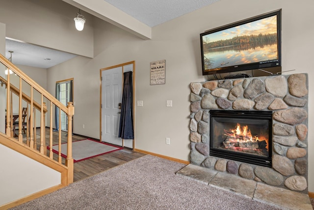 7735 Lachman Ave NE, Otsego, MN 55301 - entryway featuring a stone fireplace, carpet flooring, stairs, and a textured ceiling
