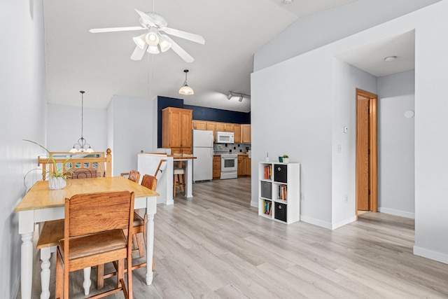 940 14th Ln SE, Cambridge, MN 55008 - dining area featuring ceiling fan, vaulted ceiling, and light wood finished floors
