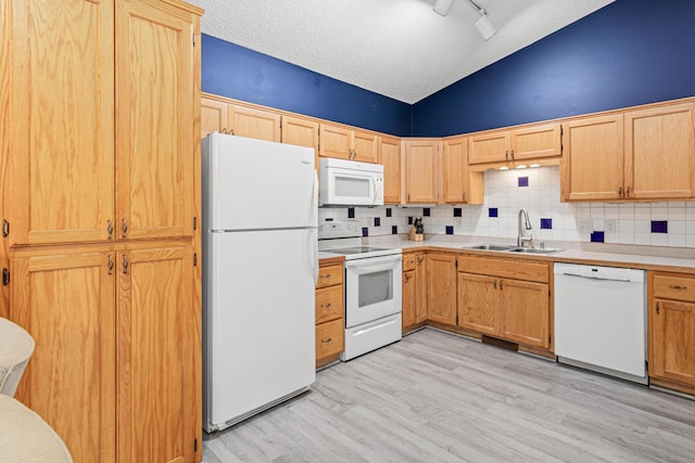 940 14th Ln SE, Cambridge, MN 55008 - kitchen featuring white appliances, tasteful backsplash, light wood-style floors, light countertops, and a textured ceiling