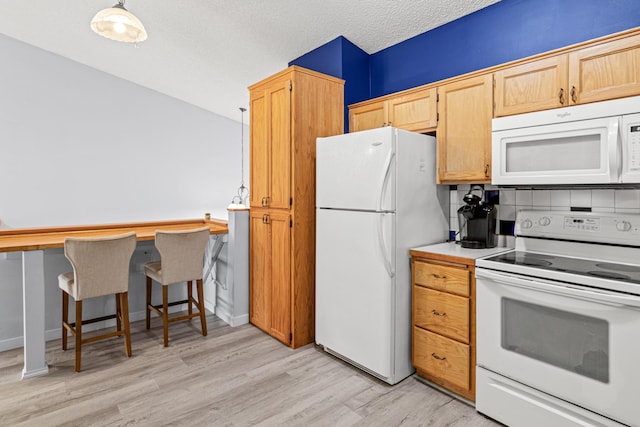 940 14th Ln SE, Cambridge, MN 55008 - kitchen with white appliances, light wood finished floors, and light countertops