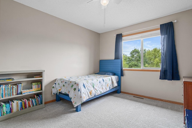 940 14th Ln SE, Cambridge, MN 55008 - carpeted bedroom with a textured ceiling and ceiling fan