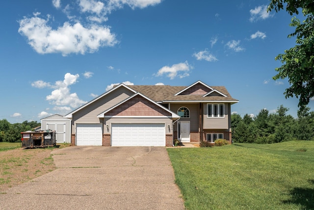 30354 118th St, Baldwin Twp, MN 55371 - view of front of house with brick siding, concrete driveway, a front lawn, an attached garage, and a storage shed