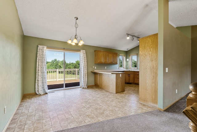 30354 118th St, Baldwin Twp, MN 55371 - kitchen with plenty of natural light, a peninsula, a chandelier, light countertops, and a textured ceiling