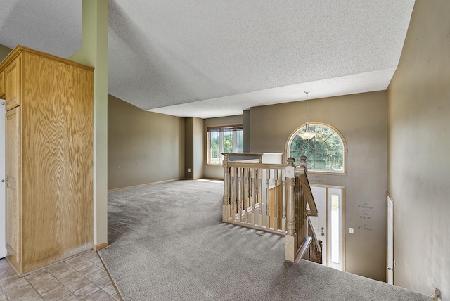 30354 118th St, Baldwin Twp, MN 55371 - hallway with an upstairs landing, a textured ceiling, and light colored carpet