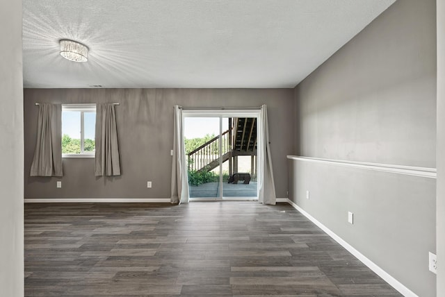 30354 118th St, Baldwin Twp, MN 55371 - unfurnished room featuring healthy amount of natural light, dark wood finished floors, and a textured ceiling