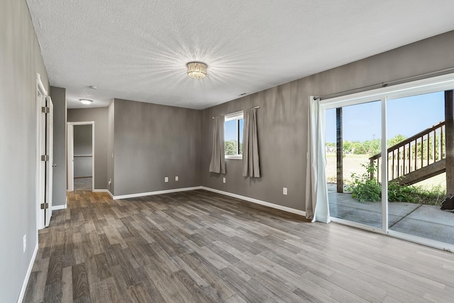 30354 118th St, Baldwin Twp, MN 55371 - unfurnished room with wood finished floors and a textured ceiling