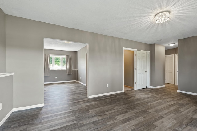 30354 118th St, Baldwin Twp, MN 55371 - unfurnished room with dark wood-style flooring and a textured ceiling