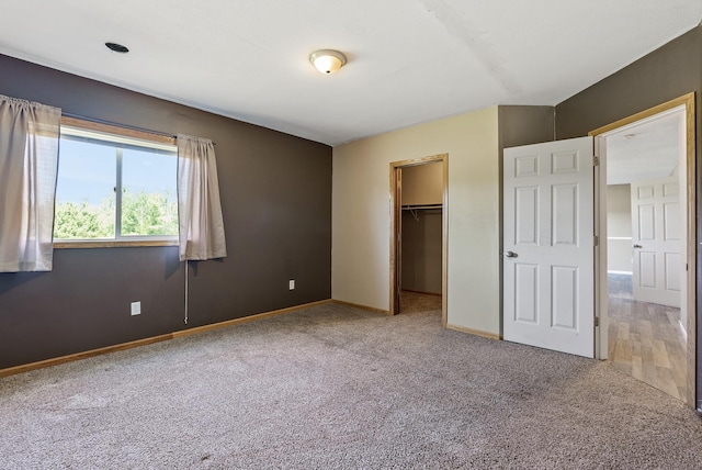 30354 118th St, Baldwin Twp, MN 55371 - unfurnished bedroom featuring carpet floors, a spacious closet, and a closet