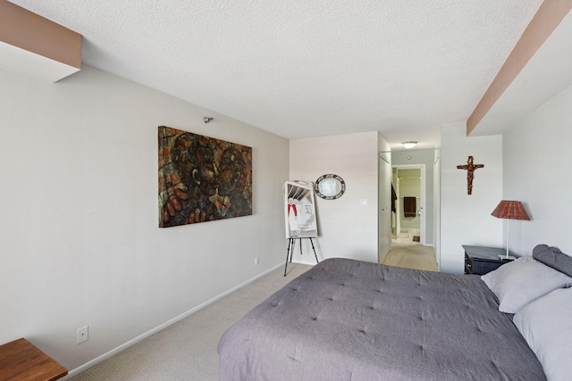 20 2nd St NE Unit P1008, Minneapolis, MN 55413 - bedroom featuring light carpet, a textured ceiling, and connected bathroom