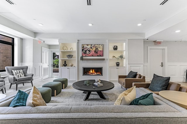 20 2nd St NE Unit P1008, Minneapolis, MN 55413 - living area with a decorative wall, a wainscoted wall, recessed lighting, a warm lit fireplace, and built in features
