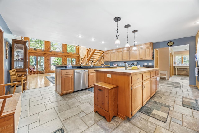 36773 Rose Lake Rd, Hobart Twp, MN 56544 - kitchen with stainless steel dishwasher, stone tile floors, an island with sink, decorative light fixtures, and recessed lighting