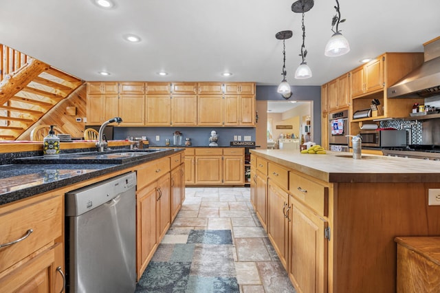 36773 Rose Lake Rd, Hobart Twp, MN 56544 - kitchen featuring appliances with stainless steel finishes, stone tile flooring, wooden counters, an island with sink, and recessed lighting
