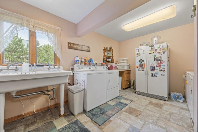 36773 Rose Lake Rd, Hobart Twp, MN 56544 - laundry room with washing machine and dryer and light stone finish flooring