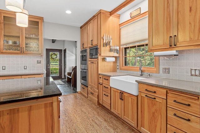 3599 210th St E, Vermillion Twp, MN 55024 - kitchen featuring tasteful backsplash, healthy amount of natural light, dark stone counters, glass insert cabinets, and recessed lighting