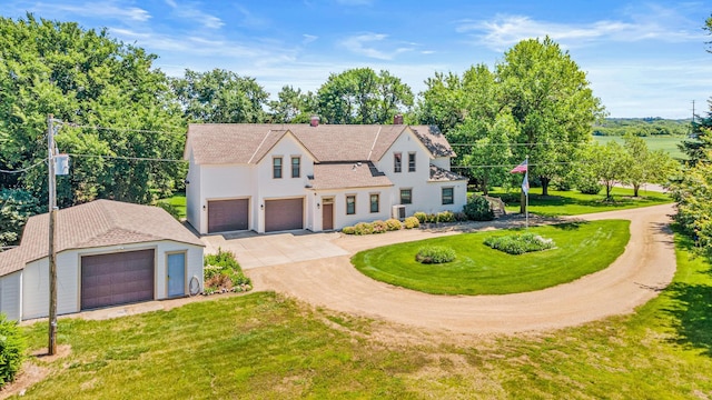 3599 210th St E, Vermillion Twp, MN 55024 - view of front of home featuring driveway, a front lawn, an attached garage, and an outdoor structure