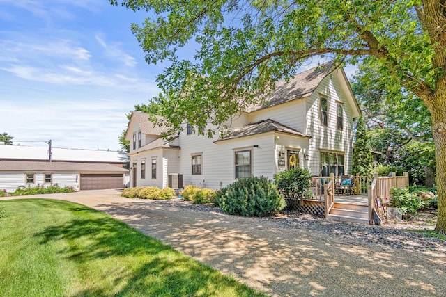 3599 210th St E, Vermillion Twp, MN 55024 - traditional home with an outbuilding, a deck, a front lawn, a garage, and a shingled roof