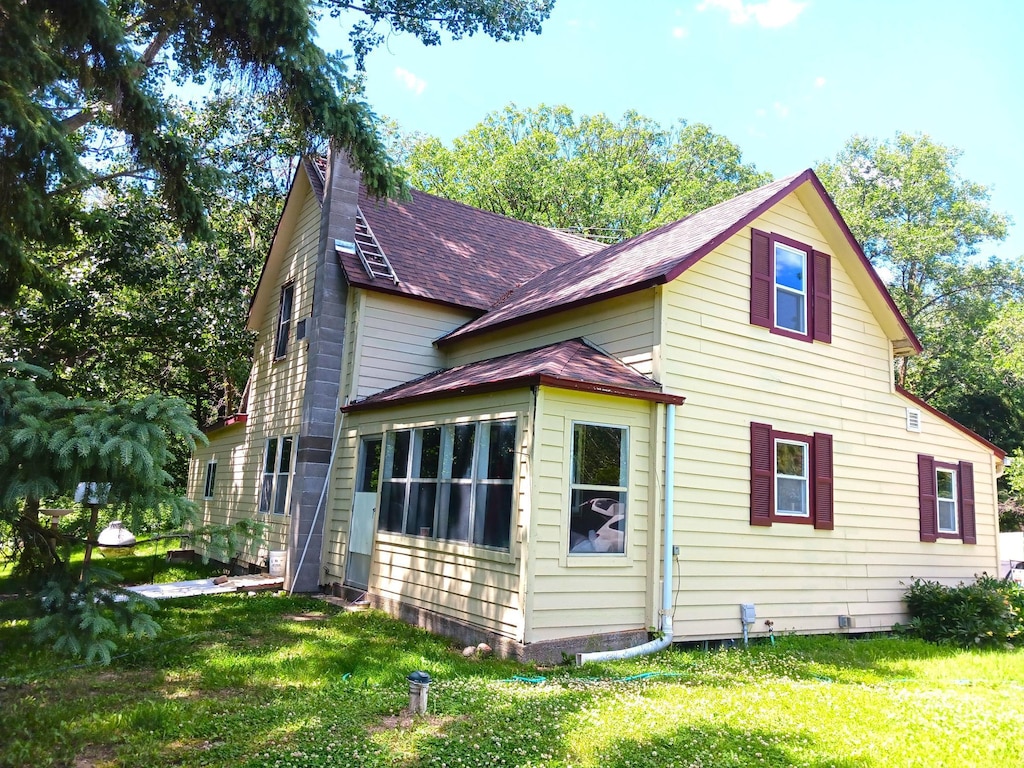 34251 190th Ave, Erhards Grove Twp, MN 56534 - view of home's exterior with roof with shingles and a yard