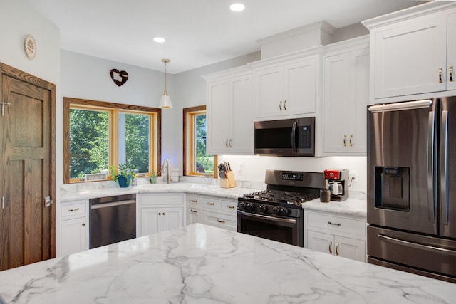 18465 Lake Ln, Chengwatana Twp, MN 55063 - kitchen featuring stainless steel appliances, white cabinets, light stone counters, recessed lighting, and decorative light fixtures