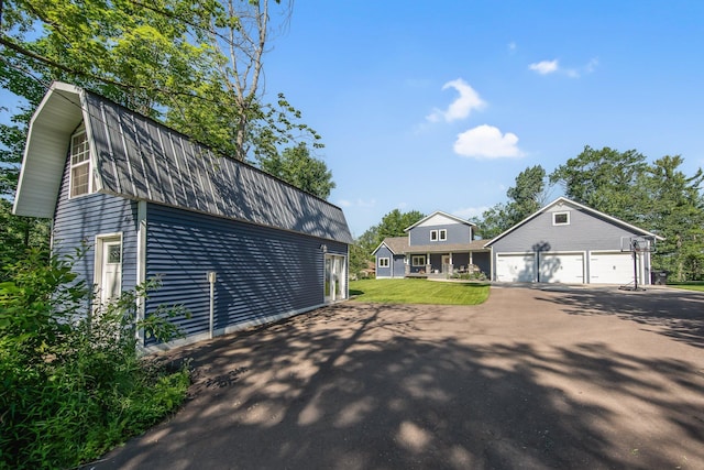 18465 Lake Ln, Chengwatana Twp, MN 55063 - view of front facade featuring a gambrel roof, a garage, driveway, and a front yard