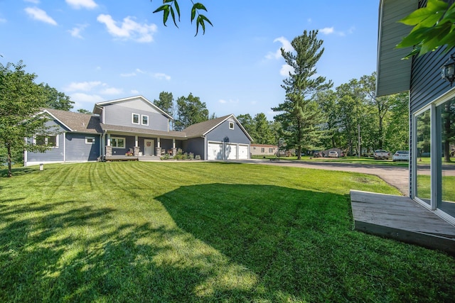 18465 Lake Ln, Chengwatana Twp, MN 55063 - view of grassy yard with covered porch, driveway, and a garage