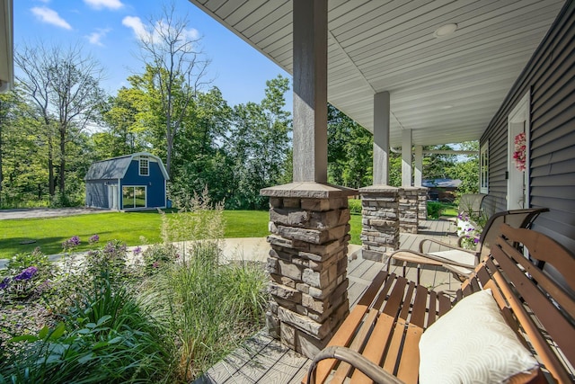 18465 Lake Ln, Chengwatana Twp, MN 55063 - covered porch with a lawn, an outdoor structure, and view of wooded area