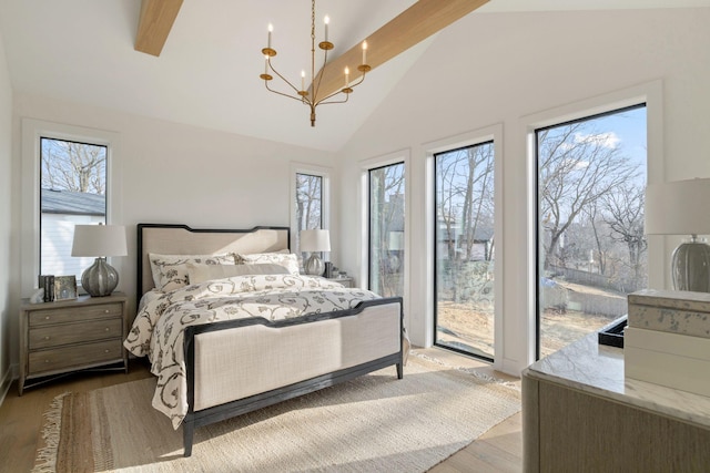 5250 Polaris Ln N, Plymouth, MN 55446 - bedroom featuring access to exterior, a chandelier, high vaulted ceiling, and wood finished floors