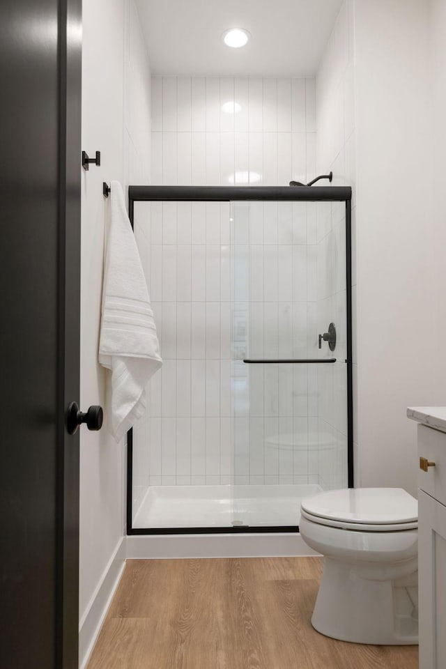 5250 Polaris Ln N, Plymouth, MN 55446 - bathroom with tiled shower, wood finished floors, vanity, and recessed lighting