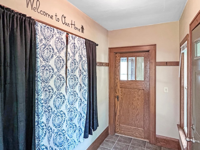 306 Jefferson St, Minneota, MN 56264 - entryway featuring dark tile patterned flooring and baseboards