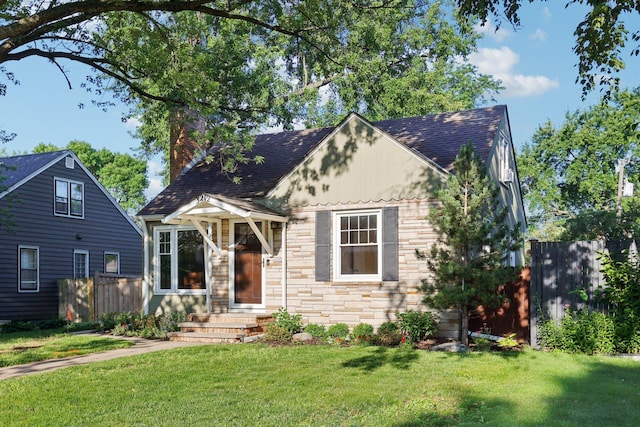 3212 Kentucky Ave S, Saint Louis Park, MN 55426 - tudor house with stone siding, a shingled roof, and a chimney