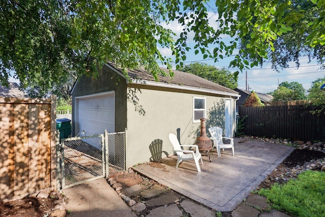 3212 Kentucky Ave S, Saint Louis Park, MN 55426 - view of patio featuring a detached garage, a gate, and an outdoor structure