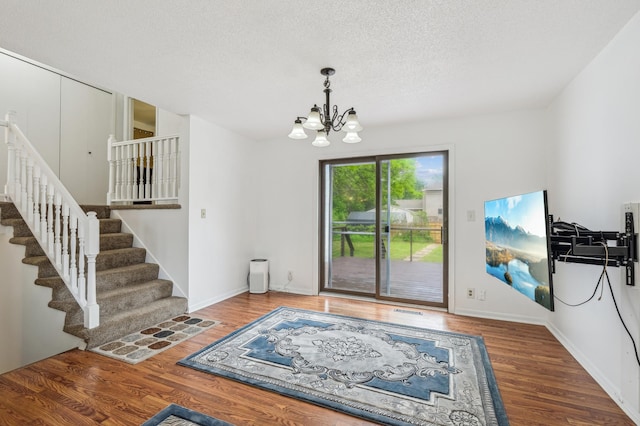 2715 90th Ln NE, Blaine, MN 55449 - entrance foyer featuring a chandelier, wood finished floors, stairway, and a textured ceiling