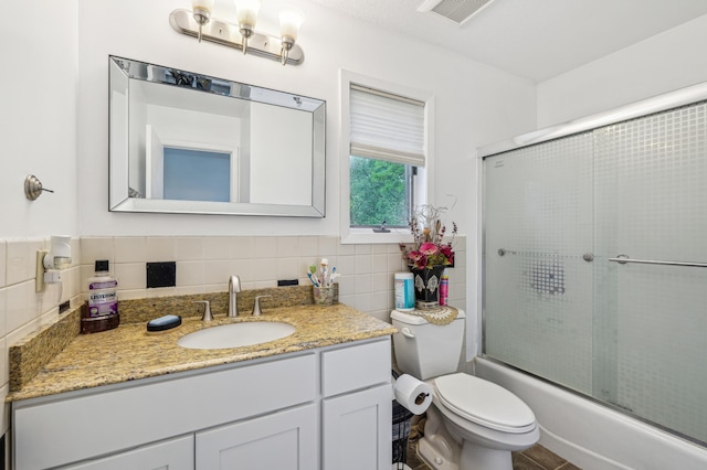 2715 90th Ln NE, Blaine, MN 55449 - full bathroom with vanity, enclosed tub / shower combo, and tile walls