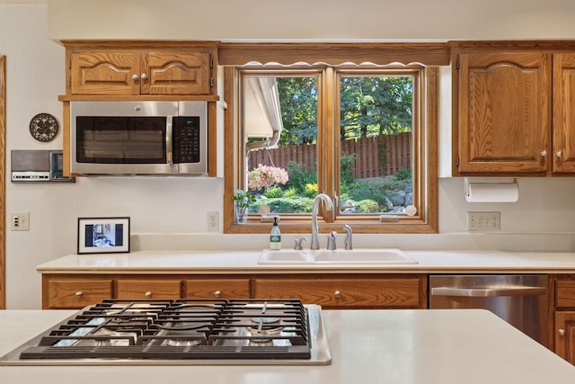 10910 38th Ave N, Plymouth, MN 55441 - kitchen with stainless steel appliances, light countertops, and brown cabinetry