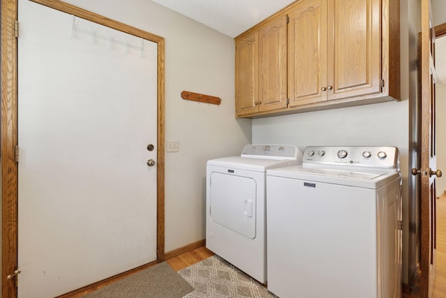 10910 38th Ave N, Plymouth, MN 55441 - washroom with washing machine and clothes dryer, cabinet space, and light wood-style flooring
