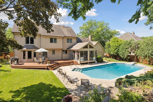10910 38th Ave N, Plymouth, MN 55441 - view of swimming pool with a wooden deck, a sunroom, a fenced backyard, and area for grilling