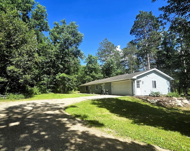 17544 366th St, Bagley, MN 56621 - view of side of property with a garage, a yard, and driveway