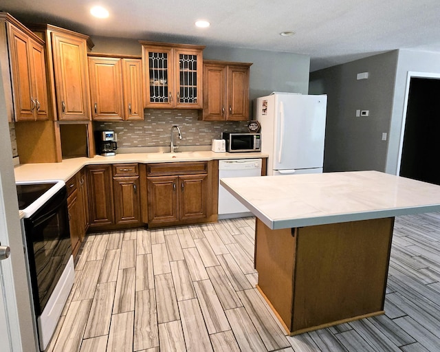 17544 366th St, Bagley, MN 56621 - kitchen with white appliances, brown cabinets, decorative backsplash, and recessed lighting