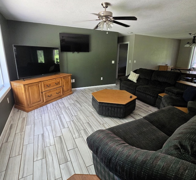 17544 366th St, Bagley, MN 56621 - living area featuring a ceiling fan, a textured ceiling, and wood tiled floors